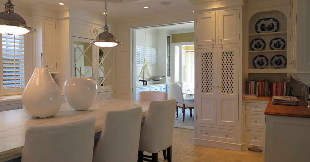 Behind lattice doors are oven and microwave – near dining room.