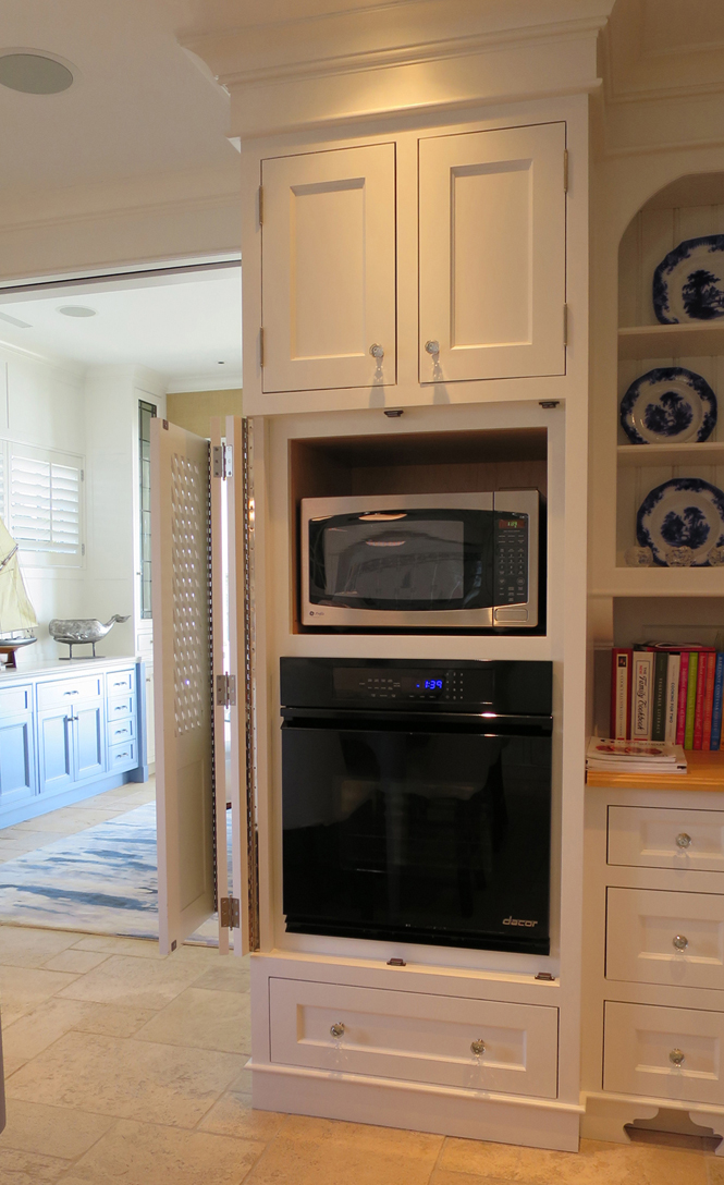 Door rolls back out of way for easy access to microwave and oven.