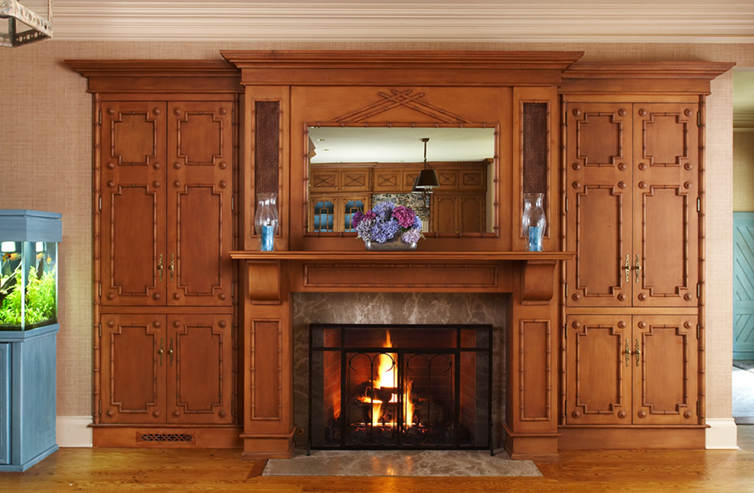 Adjacent family room area uses same bamboo theme for fireplace wall. 