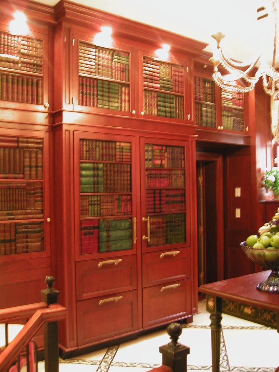 Faux books conceal refrigerator.