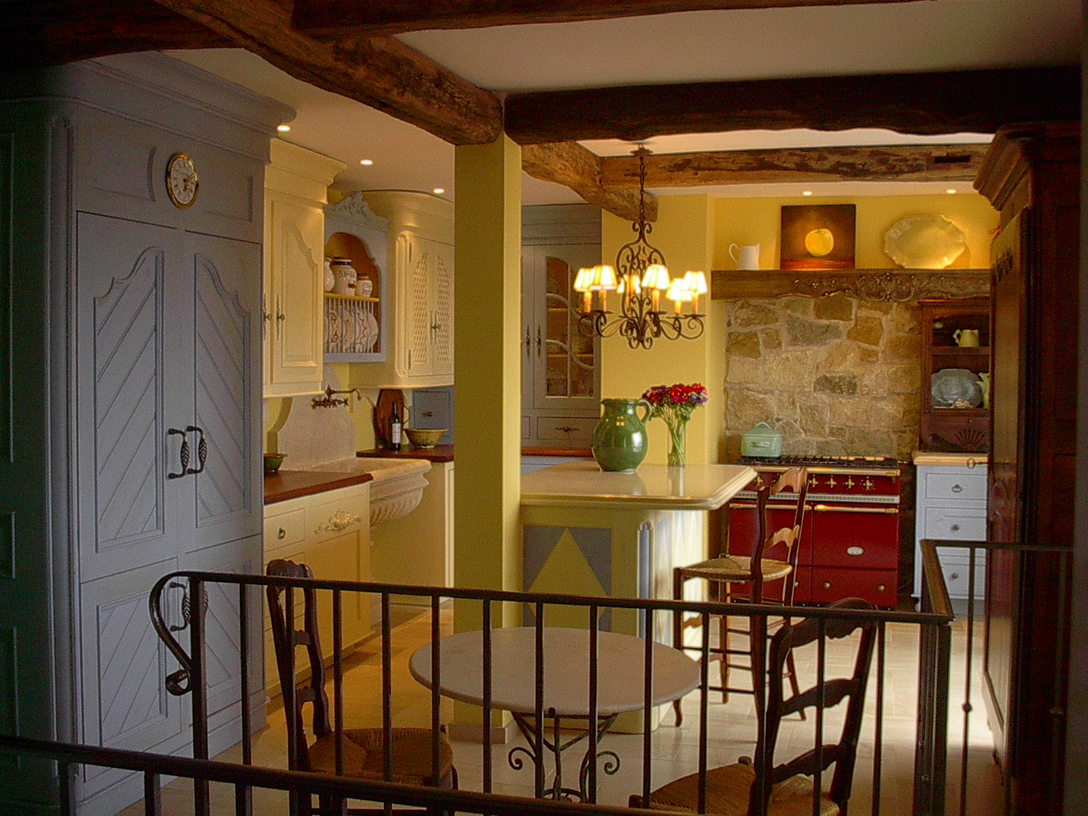 Cabinet on far left is 2 refrigerators. Cherry wood counters and the island top is lava stone